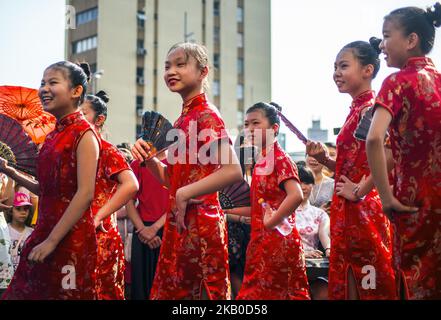 Chinese people take part in a flash mob in Sao Paulo, Brazil, on August 19, 2018. About 100 Chinese women and children accompanied by voices and traditional Chinese instruments were dressed in the typical Qipao, clothing inspired by Western fashion and today It's a fever in China. (Photo by Cris Faga/NurPhoto) Stock Photo