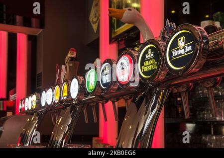 Bergen op Zoom, The Netherlands, December 29, 2019: array of beer pumps in a bar with various Dutch and Belgian craft beers on draught