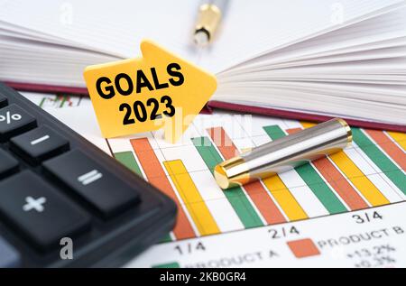 Business concept. On the business charts there is a notepad, a pen and an arrow sticker with the inscription - Goals 2023 Stock Photo