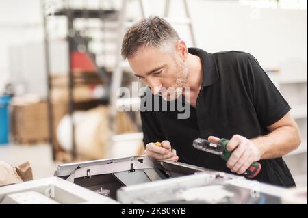 All machines nead maintains. Professional technician troubleshooting and repair the machines in the printing house. Stock Photo