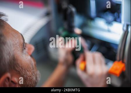 All machines nead maintains. Professional technician troubleshooting and repair the machines in the printing house. Stock Photo