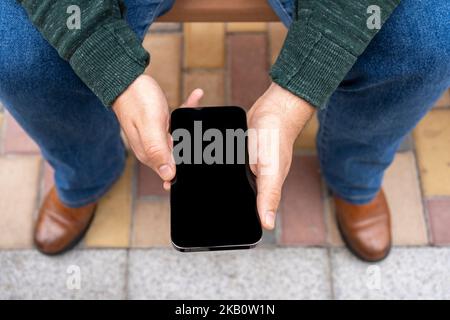 Mockup image black screen mobile phone.man holding texting using mobile relax Stock Photo