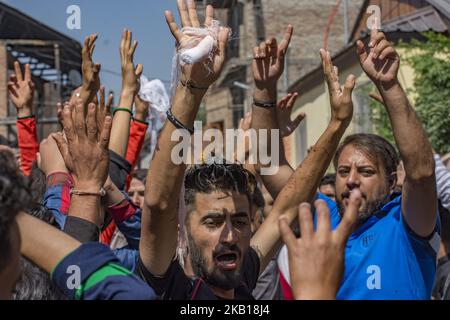 Kashmiri Shiite Muslim mourners shout religious slogans as they try to ...