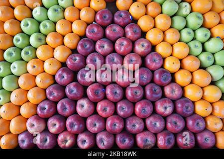 geometrically arranged red apples, oranges and green apples Stock Photo