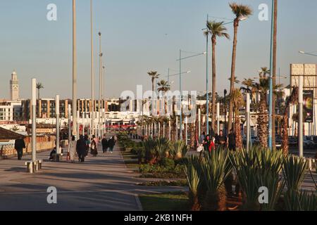 People walk along the Cornish in Casablanca, Morocco, Africa. The Cornish of Casablanca is a beautiful stretch along the Atlantic coast. The serpentine road has a parallel walkway for the pedestrians and there are a number of hotels, restaurants, and nightclubs located along the Cornish. (Photo by Creative Touch Imaging Ltd./NurPhoto) Stock Photo