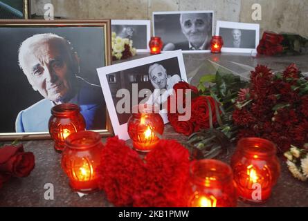 People pay homage to French-Armenian singer and actor Charles Aznavour as they lay flowers and place candles in front of the Embassy of France in Kiev, Ukraine, 02 October, 2018.The legendary French singer Charles Aznavour has died aged 94 at his home in Alpilles in southeastern France on October 1, 2018. (Photo by NurPhoto) Stock Photo