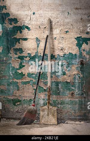 Old dirty broom and shovel Stock Photo