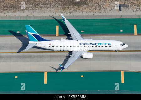 WestJet Boeing 737 aircraft taxiing. Plane C-FRWA of westjet at an airport. Airplane 737-800 of West Jet. Stock Photo