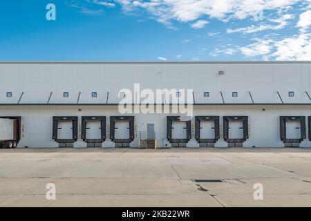 Empty loading docks of large warehouse Stock Photo