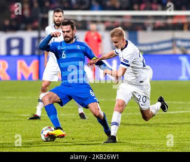 Finland's Jasse Tuominen and Greece's Alexandros Tziolis during the UEFA Nations League group stage football match Finland v Greece in Tampere, Finland on October 15, 2018. (Photo by Antti Yrjonen/NurPhoto) Stock Photo