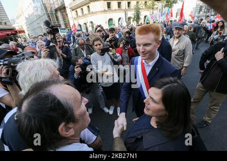 French member of Parliament of the leftist La France Insoumise (LFI) party Adrien Quatennens (R) speakswith demonstrators during a demonstration called by pensioners' unions on October 18, 2018 in Paris, to demand pensions' increase and protest against the French government policy. (Photo by Michel Stoupak/NurPhoto) Stock Photo