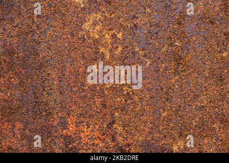 Dark light red rusty metal plate. Grunge texture. Rusty metal background. Rusty orange texture. Rust. Stock Photo