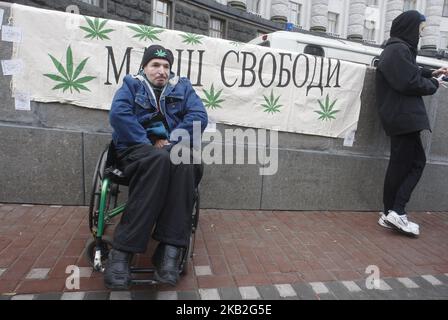 Ukrainian activists attends a rally for legalization of using of marijuana, near the Cabinet of Ministers, in Kiev,Ukraine, 27 October, 2018. A group of activists gathered to demand Ukrainian officials decriminalization and the legalization of the use of marijuana. (Photo by NurPhoto) Stock Photo