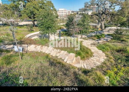 Stone brick walking trail on grassy land at Waterloo Park in Austin Texas Stock Photo