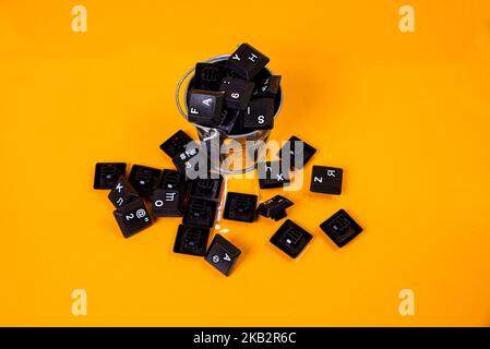 keyboard button in glass in jar in bucket on orange background isolated hacker Stock Photo
