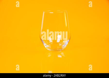 empty glass empty jar empty ice bucket on orange background top front view isolated Stock Photo