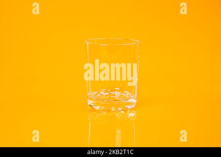 empty glass empty jar empty ice bucket on orange background top front view isolated Stock Photo