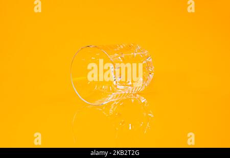empty glass empty jar empty ice bucket on orange background top front view isolated Stock Photo