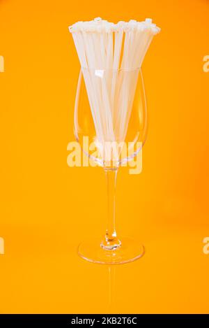 nylon cable ties in glass in jar in bucket on orange background front top view isolated Stock Photo