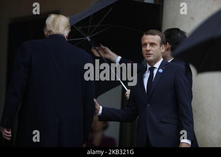 US President Donald Trump (C) is welcomed by French president Emmanuel Macron prior to their meeting at the Elysee Palace in Paris, on November 10, 2018, on the sidelines of commemorations marking the 100th anniversary of the 11 November 1918 armistice, ending World War (Photo by Mehdi Taamallah/NurPhoto) Stock Photo