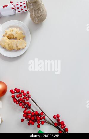 Christmas decorations and cookies, christmas tree and gifts on white table Stock Photo