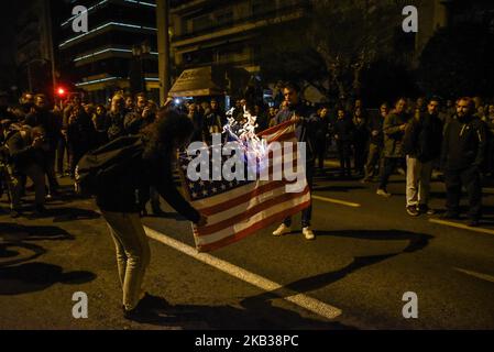 Protesters burn a US flag during an annual demonstration gathering to American embassy, commemorating the 1973 student uprising that helped topple Greece's US-backed junta, in the center of Athens on November 17, 2018. (Photo by Dimitris Lampropoulos/NurPhoto) Stock Photo