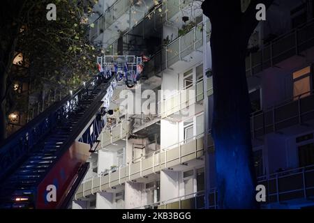 Berlin, Germany. 03rd Nov, 2022. A turntable ladder of the fire department stands by a building in Berlin-Friedrichsfelde. There, a fire had broken out in the evening in an apartment on the third floor of the eleven-story building. The fire then quickly spread to the fourth floor. More than 90 firefighters and numerous rescue workers were deployed. According to initial information, eleven residents were injured, one died on site despite resuscitation. Credit: Paul Zinken/dpa/Alamy Live News Stock Photo