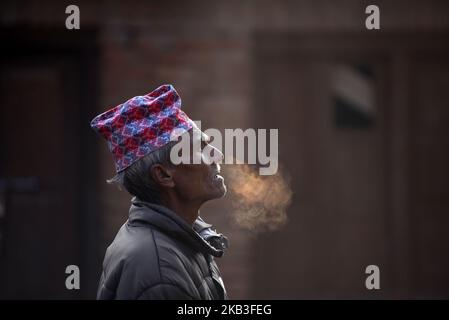 An old man arrive to observe Mahalaxmi Festival in cold morning at Thankot, Kathmandu, Nepal on Saturday, November 24, 2018. Mahalaxmi Festival is the annual festival to honor of the goddess Mahalaxmi and Ganesh are carried to the Mahalaxmi temple. A vermillion power and red colored powder, is thrown on participants and chariots as festival is accompanied by traditional music and dance. (Photo by Narayan Maharjan/NurPhoto) Stock Photo