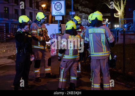 Berlin, Germany. 03rd Nov, 2022. Firefighters and police stand by a building in Berlin-Friedrichsfelde. A fire had broken out there in the evening in an apartment on the third floor of the eleven-story building. The fire then quickly spread to the fourth floor. More than 90 firefighters and numerous rescue workers were deployed. According to initial information, eleven residents were injured, one died on site despite resuscitation. Credit: Paul Zinken/dpa/Alamy Live News Stock Photo