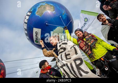 December 1st, Cologne. In December the climate is discussed twice: at the World Climate Summit in Poland, and in the coal commission in Berlin. On the 1st of December in Cologne, at the gates of the largest lignite mining area in Europe, thousands of people gathered to ask the Implementing the Paris Climate Agreement: tightening climate targets and providing fair support to poor and most affected countries in the fight against climate change. Switching off half of the coal-fired power station capacities in Germany, and so fast that the federal government’s climate target for 2020 is still reac Stock Photo