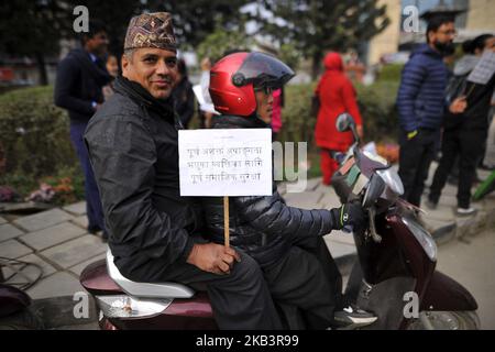 A Nepalese disabled people in a scooter hold placards during 27th International Day of Persons with Disabilities in Kathmandu, Nepal on Monday, December 03, 2018. The 27th World Disability Day focuses on 'Empowering persons with disabilities and ensuring inclusiveness and equality'. (Photo by Narayan Maharjan/NurPhoto) Stock Photo