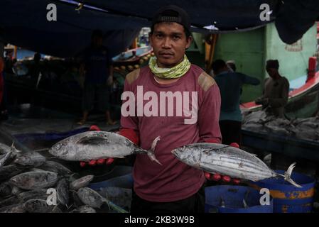 A fisherman shows a frozen tuna in Jakarta on December 5, 2018. (Photo by Anton Raharjo/NurPhoto) Stock Photo