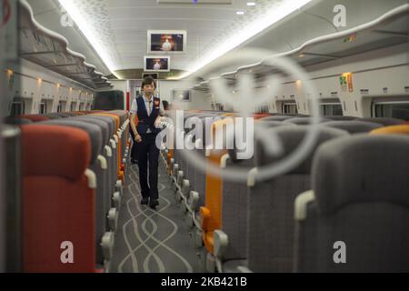 A train attendant aboard the Vibrant Express train, operated by MTR Corp is shown inside West Kowloon Station in Hong Kong, China. 13 December 2018. Today A Hong Kong court ruled that a controversial arrangement (co-location) which allows mainland Chinese officers to apply national laws at the city’s new cross-border rail terminus is legally sound, The Guangzhou-Shenzhen-Hong Kong Express Rail Link (XLR) which cost (US$10.8 billion ) went into operation on September 23.early this year. (Photo by Harry Wai/NurPhoto) Stock Photo