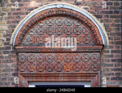Decorative brick relief on a doorway, London England United Kingdom UK Stock Photo