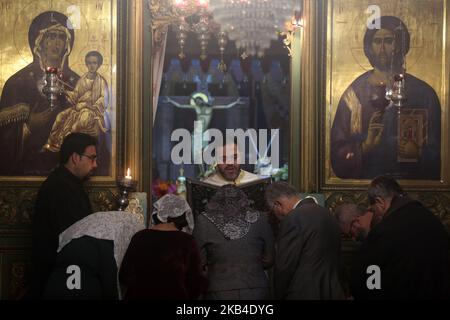 Palestinian Orthodox Christians attend a mass in the Church of Saint