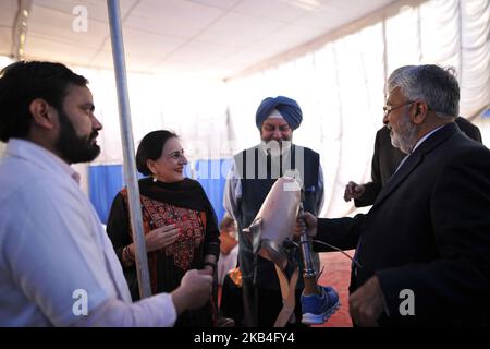 Ambassador of India to Nepal Manjeev Singh Puri and Mrs. Puri observes newly Artificial Limb to be fitted in Nepalese people during Artificial limb fitment camp in Norvic International Hospital, Kathmandu, Nepal on Sunday, January 13, 2019. The Bhagwan Mahavir Vikalang Sahayata Samiti (BMVSS) making an artificial limb camp for amputees with disability in association with Chaudhary Foundation, a charity organisation belonging to Binod Chaudhary, the first billionaire of Nepal. 500 hundred disabled people in Nepal will be provided free prosthesis 'Jaipur Foot' during an artificial limb fitment c Stock Photo