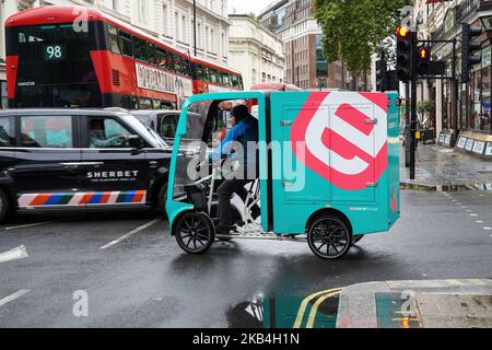 Courier on eCourier e-cargo bike in London England United Kingdom UK Stock Photo