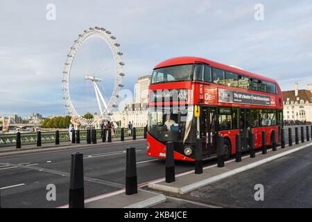 A double-decker bus on Westminster Bridge with London Eye in the background, London England United Kingdom UK Stock Photo