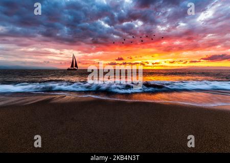 A Sailboat Sails Along The Ocean With Birds Overhead In A Colorful Paradise Tropical Beach Landscape In High Resolution Image Format Stock Photo