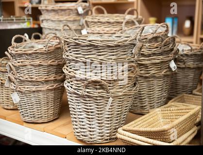 Wicker baskets on shelves in store Stock Photo