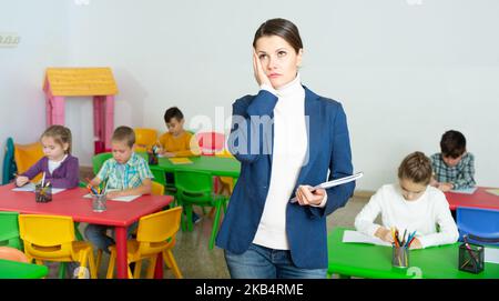 Portrait of tired teacher in elementary school class Stock Photo