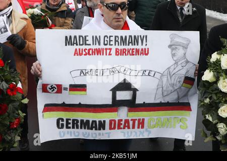 A man holds a banner 'German Death Camps' during a march organized by far-right activists and nationalistic groups on the day of the 74th anniversary of the liberation of the Nazi death camp Auschwitz-Birkenau. In Oswiecim, Poland on January 27, 2019. (Photo by Beata Zawrzel/NurPhoto) Stock Photo