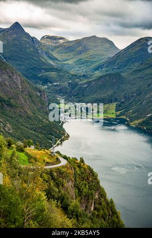 High aerial like - panorama view from Ornesvingen eagle Road observation viewpoint deck of Geirangerfjord Fjord and Geiranger village in Sunnmore region of More og Romsdal county, Storfjorden, Norway on 1st September 2019. The area of the West Norwegian Fjords is inscribed in the list of UNESCO as a World Heritage Site since 2005. The fjord is one of Norway's most visited tourist sites, Geiranger is a branch off of the Sunnylvsfjorden, which is a branch off of the Storfjorden (Great Fjord), part of the steep Trollstigen mountain road . (Photo by Nicolas Economou/NurPhoto) Stock Photo