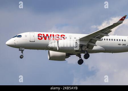 Swiss Airlines Bombardier BD-500 CSeries CS100 or Airbus A220-100 as seen on final approach landing at London Heathrow International airport LHR EGLL in England, UK during a cloudy summer day. The modern aircraft has the registration HB-JBB, 2x Pratt & Whitney PW1524G jet engines and name Canton de Genève. Swiss International Air Lines LX SWR is the flag carrier of Switzerland, owned by Lufthansa Group and member of Star Alliance aviation group. The airline carrier was the worldwide launch customer of Canadian Bombardier CS100/CS300 now A220 performing both as regional but medium haul flights  Stock Photo