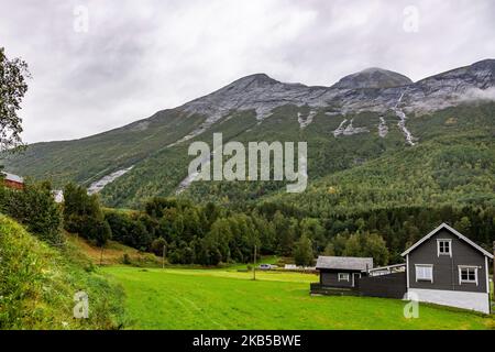 Beautiful waterfalls inside intense nature in dramatic scenery with clouds or green forest natural environment, seen at the fjords in Norway with forests and steep mountains. Water coming from high altitude mountain peaks and glaciers ending up throughValldola river to the fjords and the sea at the area of Valldal and Valldalen valley on 31 August 2019. (Photo by Nicolas Economou/NurPhoto) Stock Photo