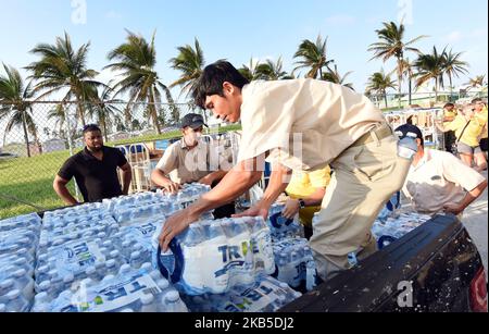 Crew members of Royal Caribbean International's Mariner of the Seas load cases of drinking water for Hurricane Dorian victims into a pickup truck on September 7, 2019 in Freeport, Bahamas. The ship is also providing an estimated 300 Freeport evacuees of the storm with food, water, an opportunity to take a shower, as well as transportation to Nassau, New Providence. (Photo by Paul Hennessy/NurPhoto) Stock Photo