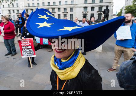 A woman wearing a hat with EU flag joins demonstrators gathered outside Downing Street on 07 September, 2019 in London, England to take part in “Stop the Coup” protests against the prorogation of the UK Parliament and to demand Boris Jonhson's resignation as Prime Minister. Prime Minister Boris Johnson reportedly suggested he could break the law, expected to receive royal assent on Monday, requiring him to seek an extension of article 50 if no Brexit agreement is in place by 19 October. (Photo by WIktor Szymanowicz/NurPhoto) Stock Photo