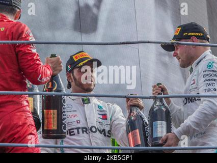 Winner Ferrari's Monegasque driver Charles Leclerc (L) celebrates next to second placed Mercedes' Finnish driver Valtteri Bottas (R) and third placed Mercedes' British driver Lewis Hamilton (C) on the podium after the Italian Formula One Grand Prix at the Autodromo Nazionale circuit in Monza on September 8, 2019.. (Photo by Robert Szaniszlo/NurPhoto) Stock Photo
