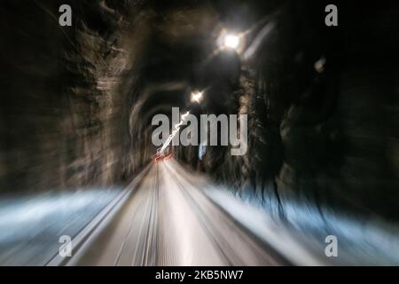 Pan; blur; time-exposure in Anton Anderson Memorial Tunnel under Maynard Mountain is shared by automobiles and the railroad. Whittier to Portage; Alas Stock Photo