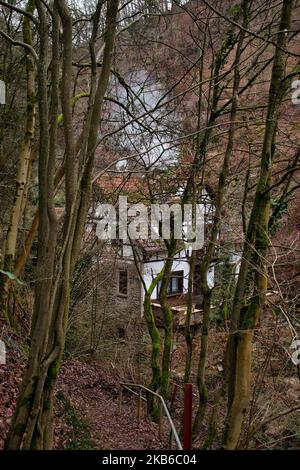 Trechtingshausen, Germany - January 2, 2021: Small house in the Bingen Forest with smoke coming out of the chimney on a winter day in Germany. Stock Photo